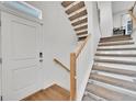 Modern light wood staircase with carpeted steps at 4072 N Rome St, Aurora, CO 80019
