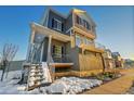 Two-story home with modern gray siding and snow at 4072 N Rome St, Aurora, CO 80019