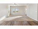 Spacious living room with hardwood floors and ceiling fan at 2985 Oxley St, Strasburg, CO 80136