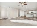 Open concept living room and kitchen with hardwood floors at 2985 Oxley St, Strasburg, CO 80136