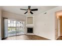 Living room with fireplace and sliding door to patio at 10165 E Carolina Pl # 102, Aurora, CO 80247