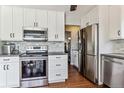 Modern kitchen with stainless steel appliances and white cabinetry at 7321 S Quarry Mountain Rd, Littleton, CO 80127