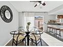 Dining area with glass table and access to backyard patio at 12584 W Virginia Ave, Lakewood, CO 80228