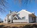 Exterior view of building showcasing stairs and siding at 8701 Huron St # 10-210, Thornton, CO 80260