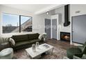 Living room with fireplace and green sofas at 8701 Huron St # 10-210, Thornton, CO 80260