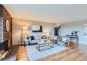 Living room with fireplace and hardwood floors at 480 S Marion Pkwy # 1601, Denver, CO 80209