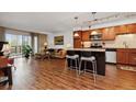Open living room and kitchen with hardwood floors at 725 S Alton Way # 3B, Denver, CO 80247