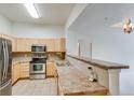 Well-equipped kitchen featuring stainless steel appliances and light wood cabinets at 7931 W 55Th Ave # 112, Arvada, CO 80002