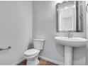 Clean and simple bathroom with toilet and sink at 9972 Wheeling St, Commerce City, CO 80022