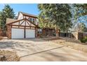 Two-story house with a two-car garage and mature trees at 2577 S Eagle Cir, Aurora, CO 80014