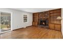 Gathering room with fireplace and built-in wooden shelving at 2577 S Eagle Cir, Aurora, CO 80014