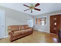 Living room with hardwood floors, a couch, and a view of the backyard at 7866 W 17Th Ave, Lakewood, CO 80214