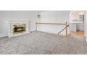 Living room with fireplace and view of kitchen at 16812 E Mansfield Cir, Aurora, CO 80013