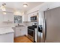 Kitchen with stainless steel appliances and white cabinets at 16812 E Mansfield Cir, Aurora, CO 80013