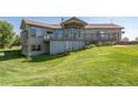 Two-story home with a large deck and a nicely landscaped yard at 2203 S County Road 185, Byers, CO 80103
