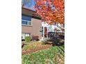 Front entrance of a brick ranch home with landscaping and autumn leaves at 6353 Pierson St, Arvada, CO 80004