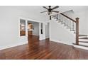 Spacious living room with hardwood floors and a view of the staircase leading upstairs at 640 Pacific Ave, Fort Lupton, CO 80621