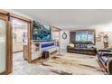 Bright living room with fireplace and kitchen access at 6039 W Fair Dr, Littleton, CO 80123