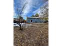 Spacious backyard with mature trees and a partially visible home at 16032 E Floyd Ave, Aurora, CO 80013