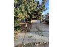 Ranch style home with attached two-car garage and mature trees at 16032 E Floyd Ave, Aurora, CO 80013