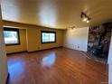 Spacious living room featuring hardwood floors and a stone fireplace at 2318 S Rifle St, Aurora, CO 80013