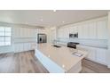 Modern kitchen with white cabinetry, quartz countertops, and stainless steel appliances at 533 Penn Rd, Elizabeth, CO 80107