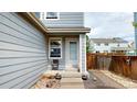 Private patio area with gray siding and landscaping at 762 Mockingbird Ln, Brighton, CO 80601
