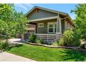 House exterior showcasing green siding and landscaping at 6988 S Riverwood Way, Aurora, CO 80016