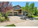 House exterior, two-car garage, and landscaped yard at 6988 S Riverwood Way, Aurora, CO 80016