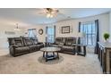 Spacious living room with comfy leather sofas at 6317 Wescroft Ave, Castle Rock, CO 80104