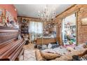 Spacious living area with exposed brick wall and a chandelier at 4507 Josephine St, Denver, CO 80216