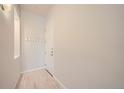 Simple entryway with light wood floors and white walls at 1489 Steele St # 302, Denver, CO 80206