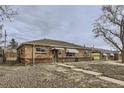 Brick ranch home with a carport and landscaping at 9030 Hickory Pl, Thornton, CO 80229