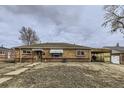 Ranch style brick home with a carport at 9030 Hickory Pl, Thornton, CO 80229