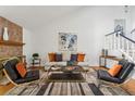 Bright living room with stone fireplace and comfortable seating at 3228 S Xanadu St, Aurora, CO 80014