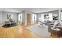 Bright living room with hardwood floors, featuring a comfortable seating area and dining space at 5501 E Colorado Ave, Denver, CO 80222