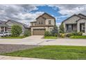 Two-story house with a two-car garage and landscaping, wide view at 9884 Eagle River St, Littleton, CO 80125