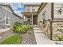 House exterior with stone and siding, walkway and landscaping at 9884 Eagle River St, Littleton, CO 80125