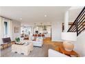 Bright living room with hardwood floors and an open concept kitchen at 5624 Cottontail Dr, Longmont, CO 80503