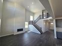 Spacious living room with high ceilings, hardwood floors, and a fireplace at 5672 Red Pebble Pt, Castle Rock, CO 80104