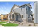 Two-story home with gray siding and stone accents at 2848 Nectar St, Strasburg, CO 80136