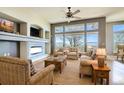 Spacious living room with fireplace, large windows, and comfortable seating at 13505 W 86Th Dr, Arvada, CO 80005