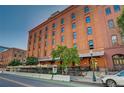 Building's exterior with street-level patio and urban backdrop at 1792 Wynkoop St # 502, Denver, CO 80202