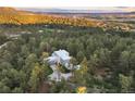 Luxury home with large driveway surrounded by trees at 7 Elk Pointe Ln, Castle Rock, CO 80108