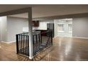 Open living area with hardwood floors and modern staircase at 3092 S Kearney St, Denver, CO 80222