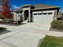 Modern home with two-car garage and landscaped front yard at 8885 S Tibet Ct, Aurora, CO 80016