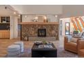 Living room with a stone fireplace and wood floors at 225 Bristlecone Way, Boulder, CO 80304