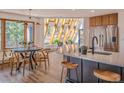 Modern kitchen with island, stainless steel appliances, and mountain views at 225 Bristlecone Way, Boulder, CO 80304