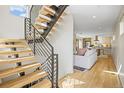 Modern light wood staircase with metal railing, offering an open view to the living area at 1415 Irving St, Denver, CO 80204