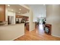 Open kitchen with granite countertops, stainless steel appliances, and hardwood floors at 6678 S Shawnee Ct, Aurora, CO 80016